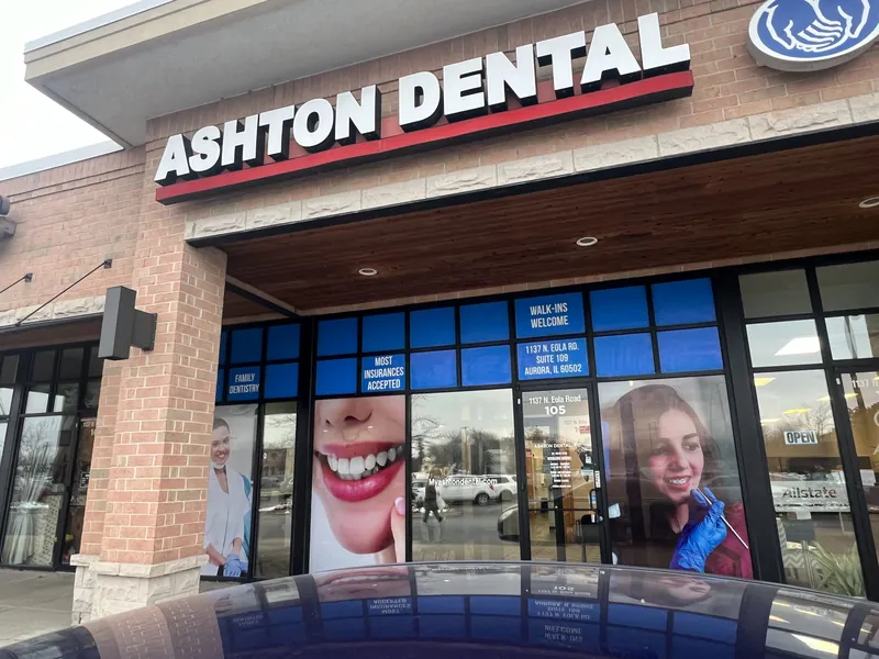 Ashton Dental storefront with a red and black building sign and blue printed window graphics
