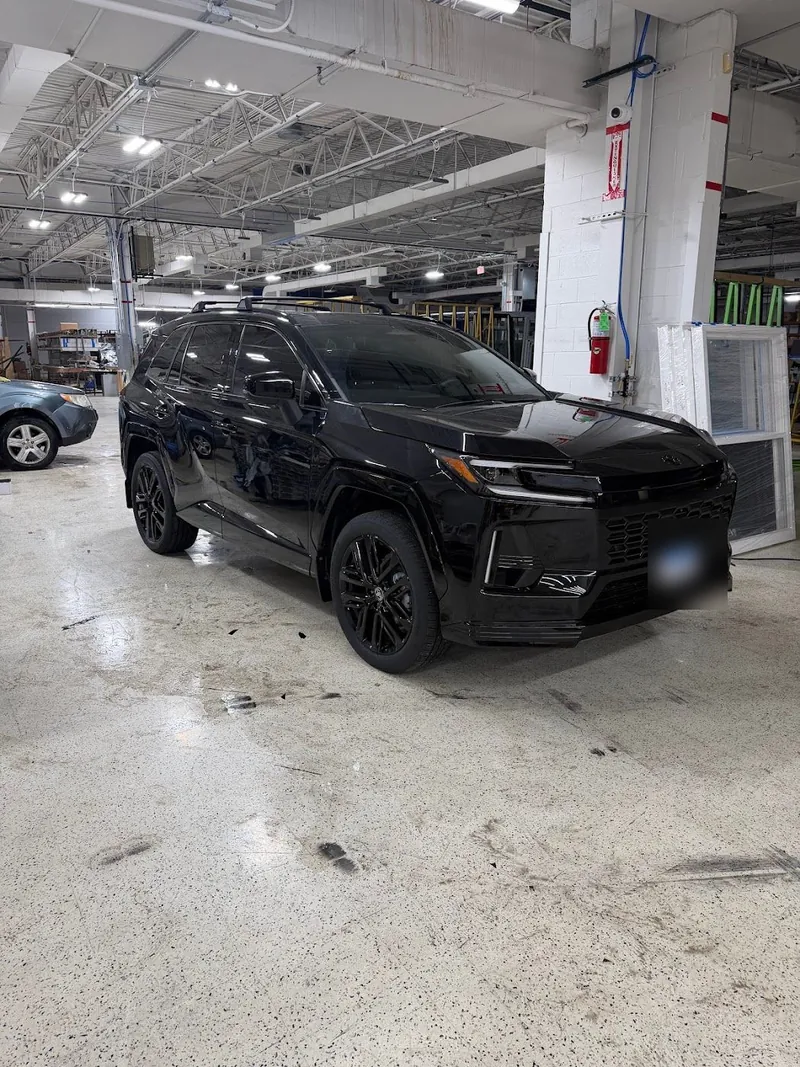 Black SUV with blacked-out trim and tinted windows in the shop