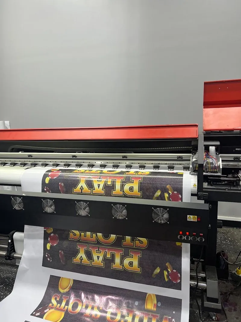 Wide-format printer printing a colorful casino-style Play graphic onto vinyl