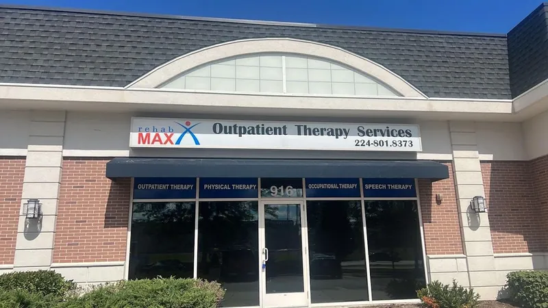 Building with a Rehab Max Outpatient Therapy Services sign and blue window headers for outpatient, physical, occupational and speech therapy