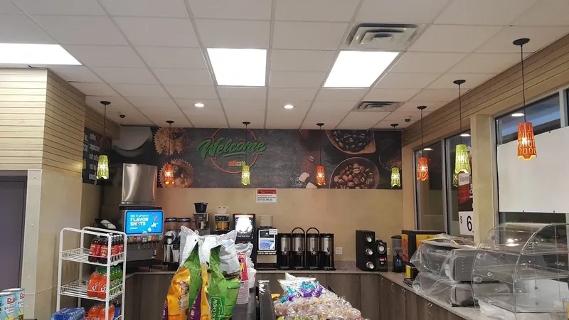 Dark food-themed wall graphics above the counter of a quick-service restaurant