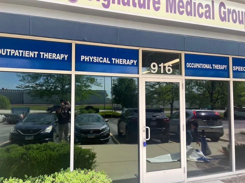 Blue window headers reading Outpatient Therapy, Physical Therapy and Occupational Therapy across a storefront under the Signature Medical Group sign