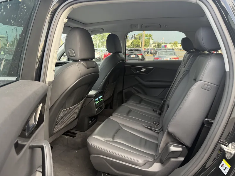 Interior of an SUV from the rear seat looking out through tinted side windows